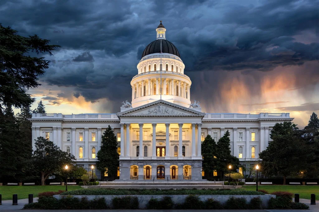 California State Capitol at dusk under storm clouds as Newsom AI regulation order targets AI kill switches